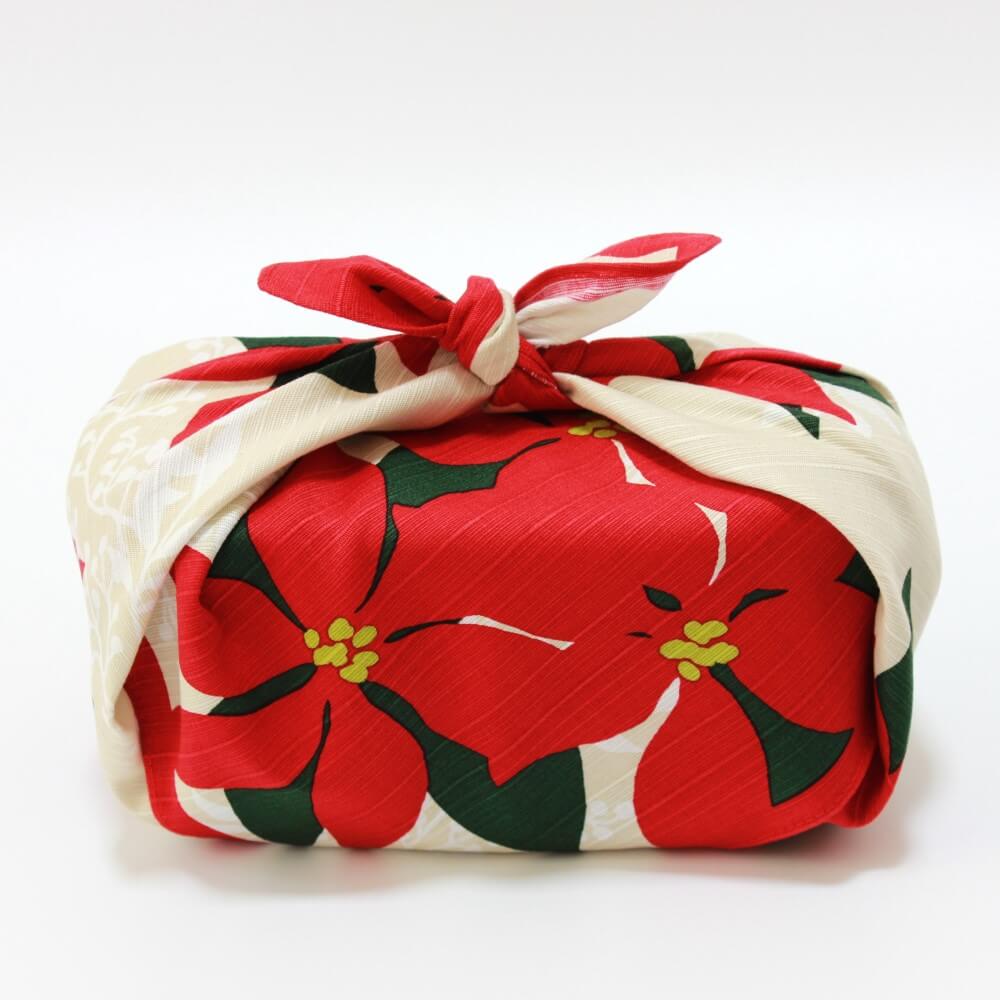 side view bento box wrapped in poinsettia red furoshiki