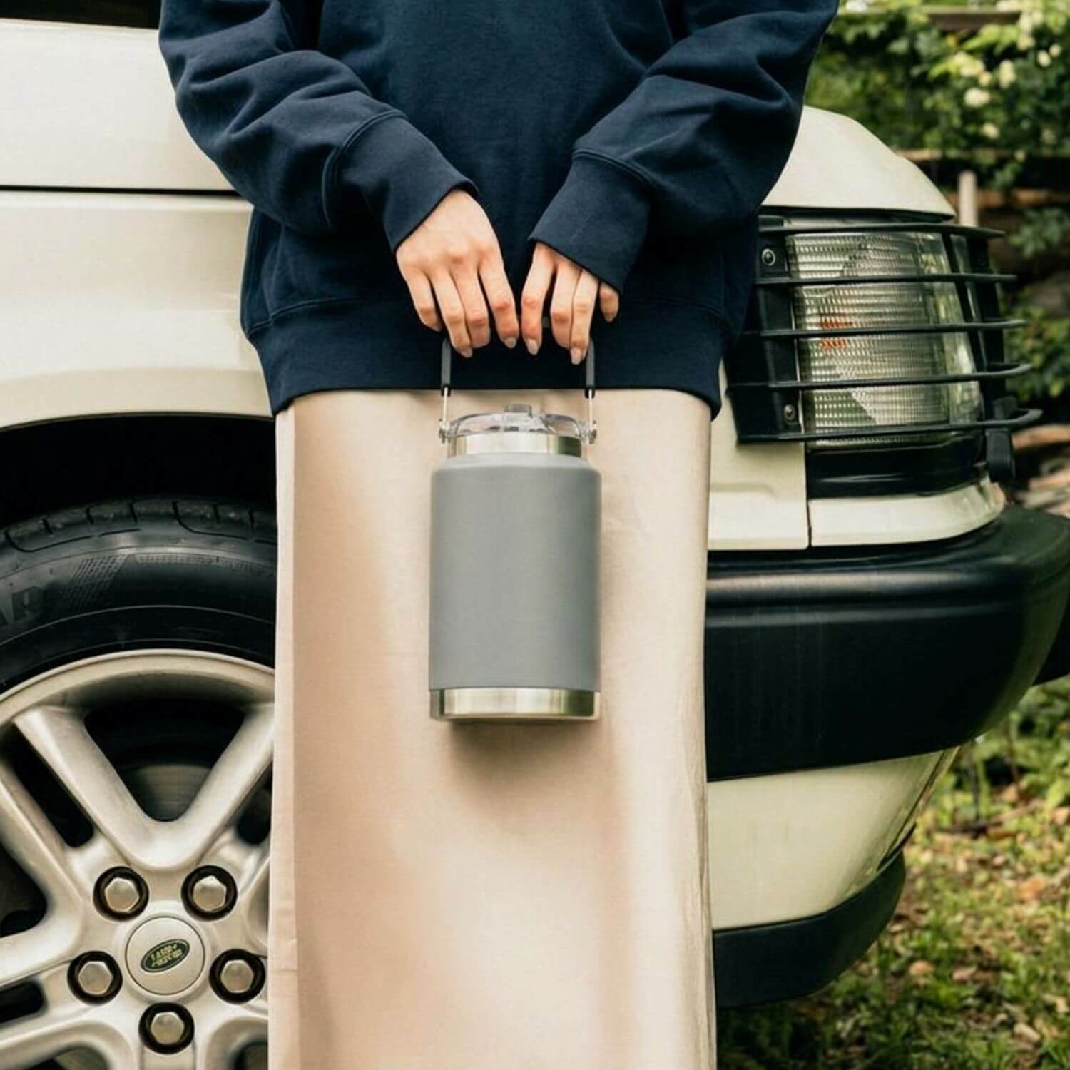 grey torus bottle being held by a lady
