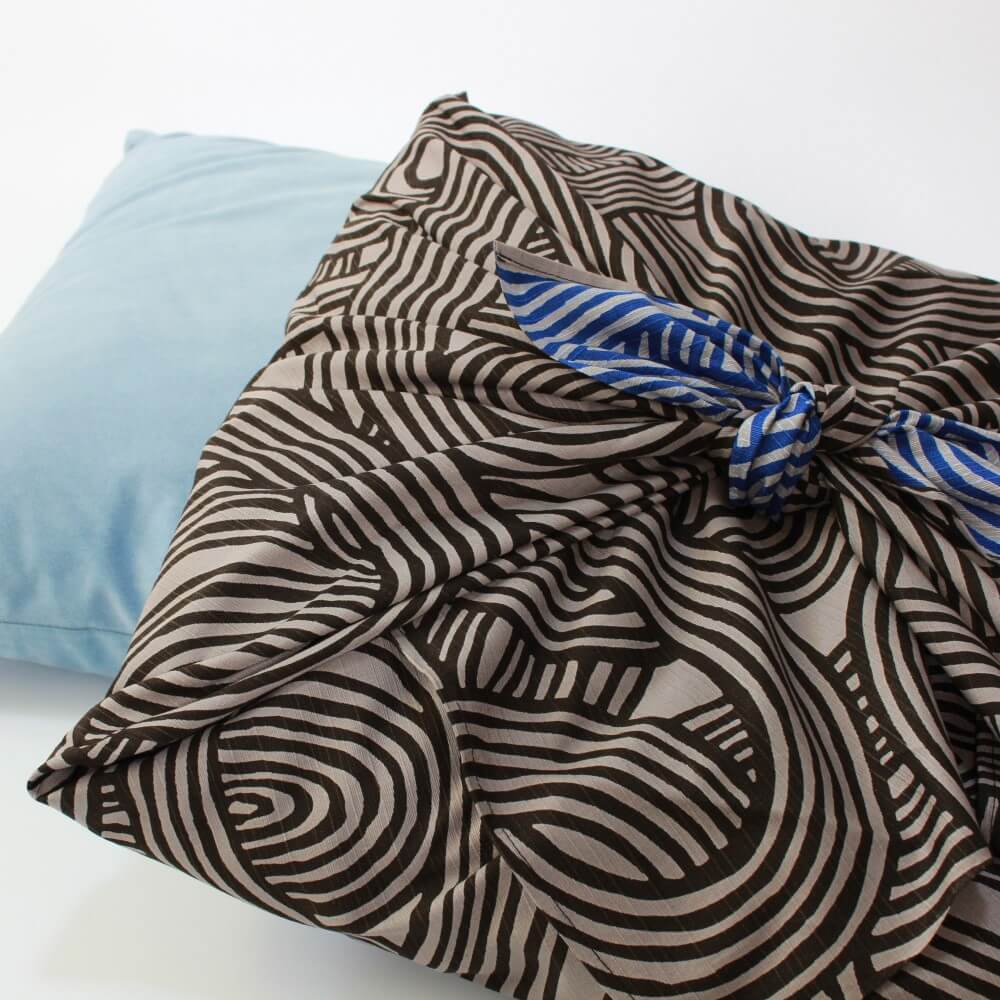 two cushions with one wrapped with knot dark grey furoshiki