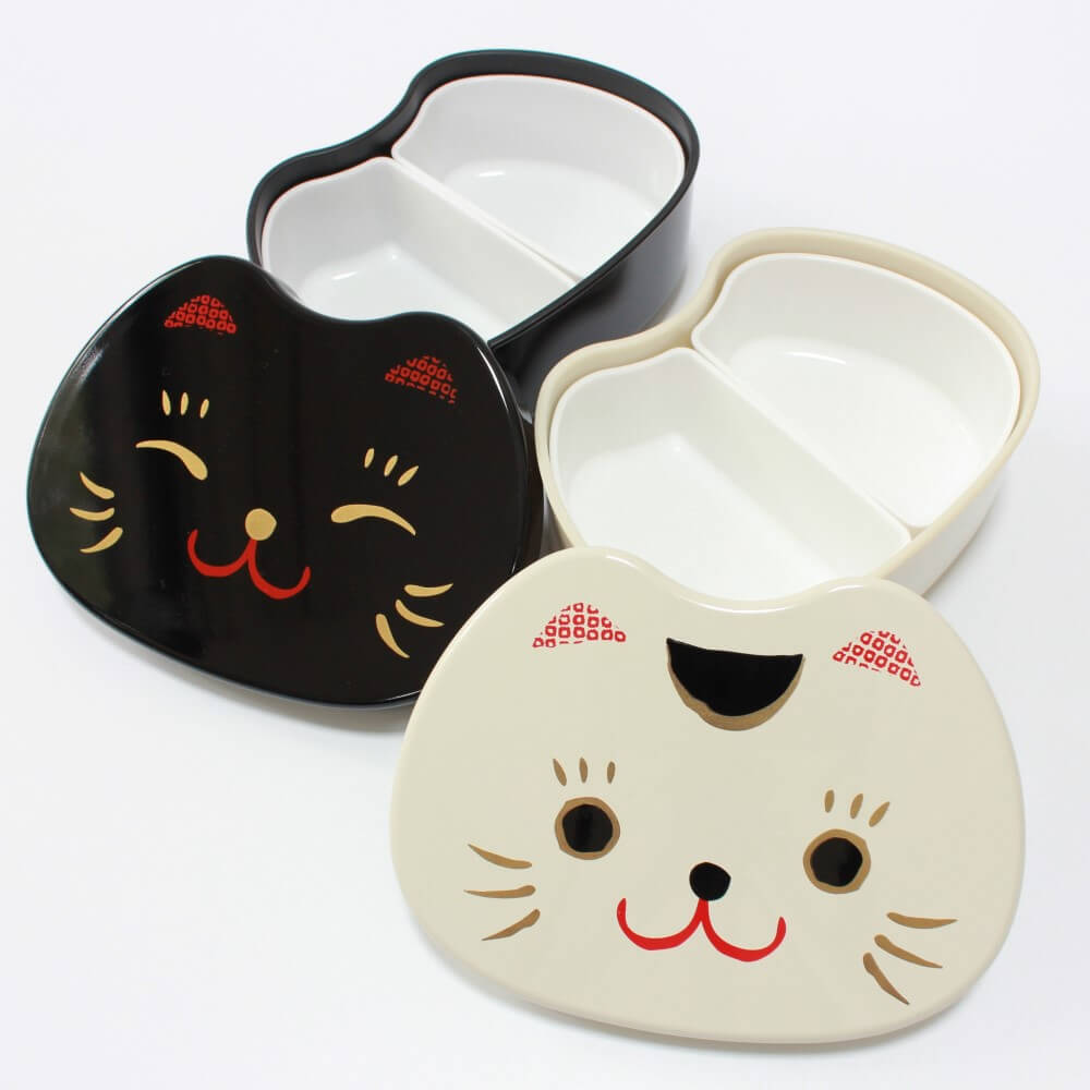 white and black cat face bento boxes with lids off