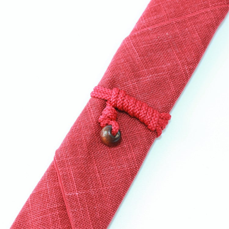 Close up shot showing the string that has secured a chopsticks case made of fabric