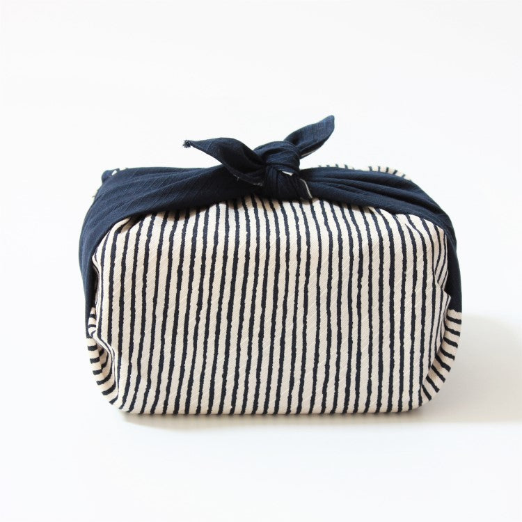 Side view of the hama monyo shima navy blue furoshiki wrapping a bento box