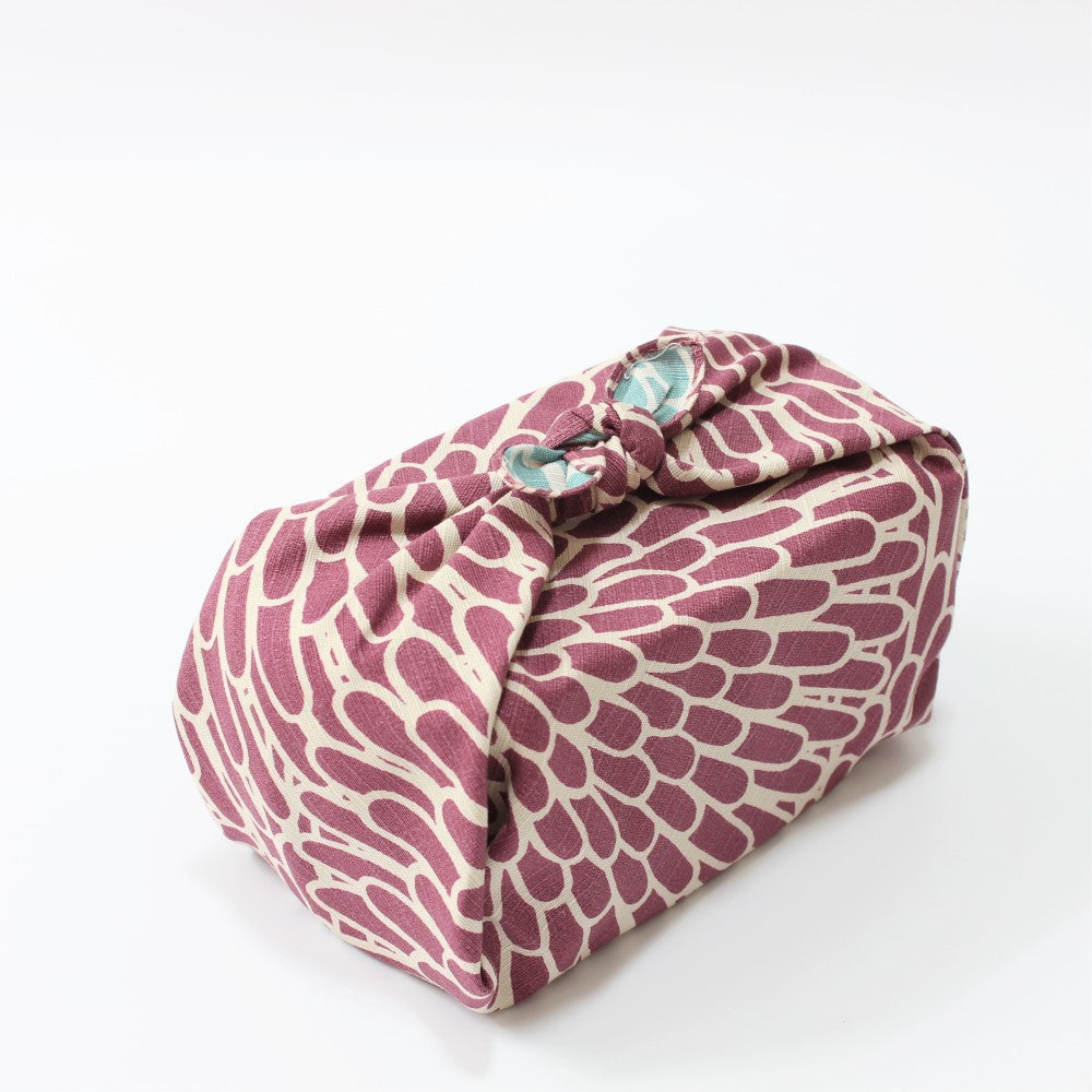 Top angle view of the furoshiki wrapped around a bento box. 