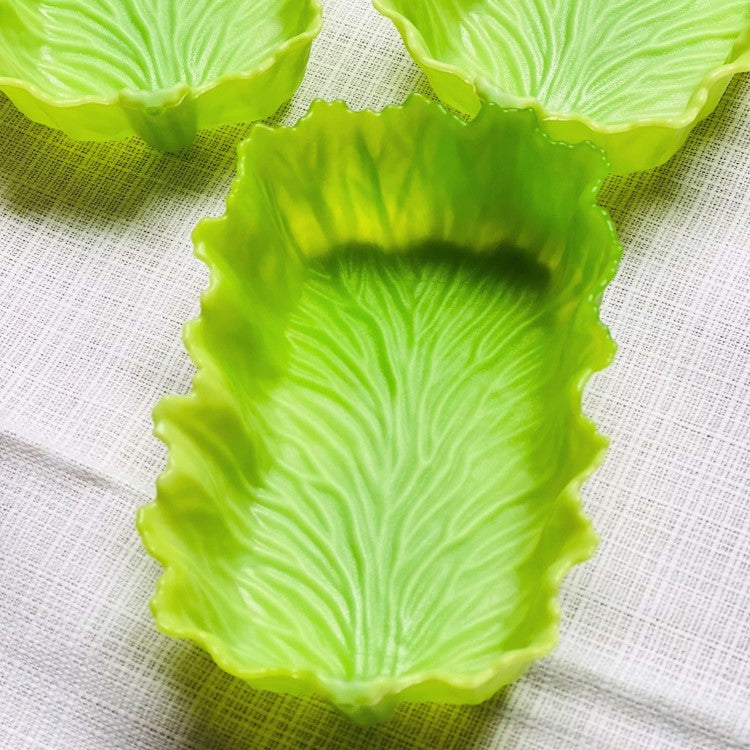 Close up shot showing one green lettuce leaf shaped rectangle divider cup