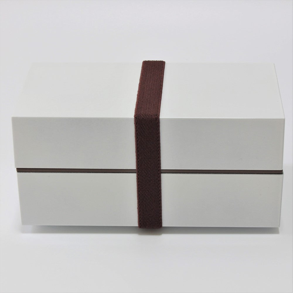 Side view showing a lunch band securing the two layers comprising this bento lunch box from Japan