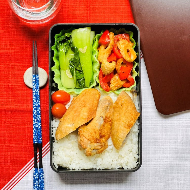 Bento box showing the lettuce divider cup inside with food