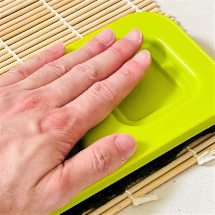 push hard to shape rice inside the mould. 