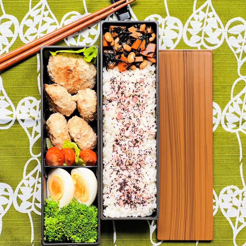 Photo showing japanese hamburg steak, rice and other sides in the natural woodgrain long slim 2 tier bento box at Majime Life
