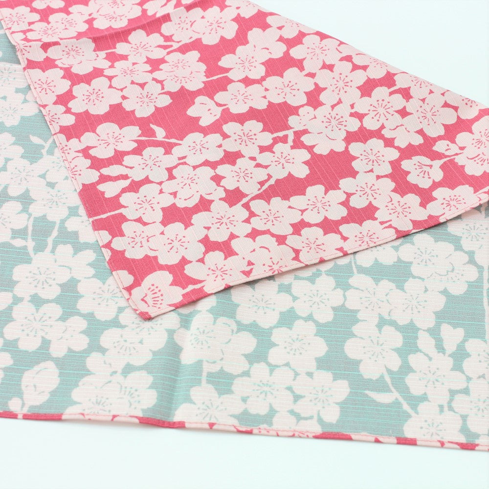 Full view showing the white sakura flowers on a pink and blue background furoshiki