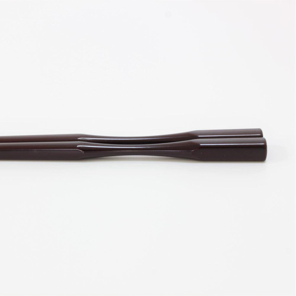 Close up showing the curved necks of the Majime Life Ohashi Collection chopsticks Teak Grain