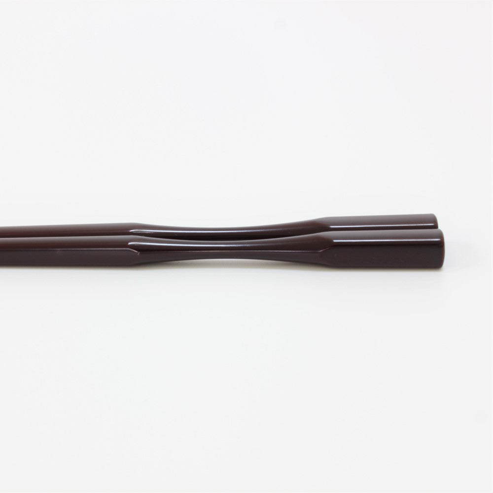Close up showing the curved necks of the Majime Life Ohashi Collection chopsticks Teak Grain