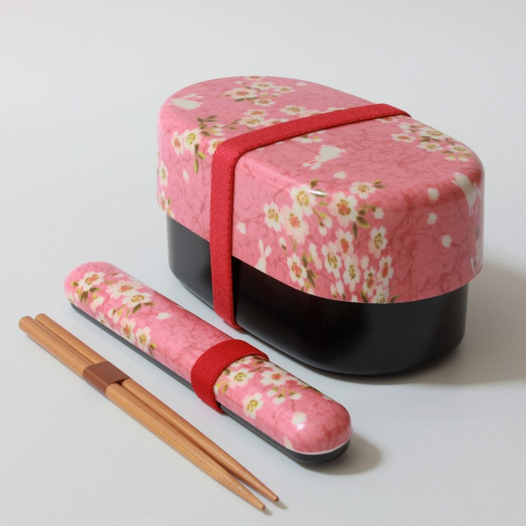 side view shot of chopsticks case with chospticks and pink bento box