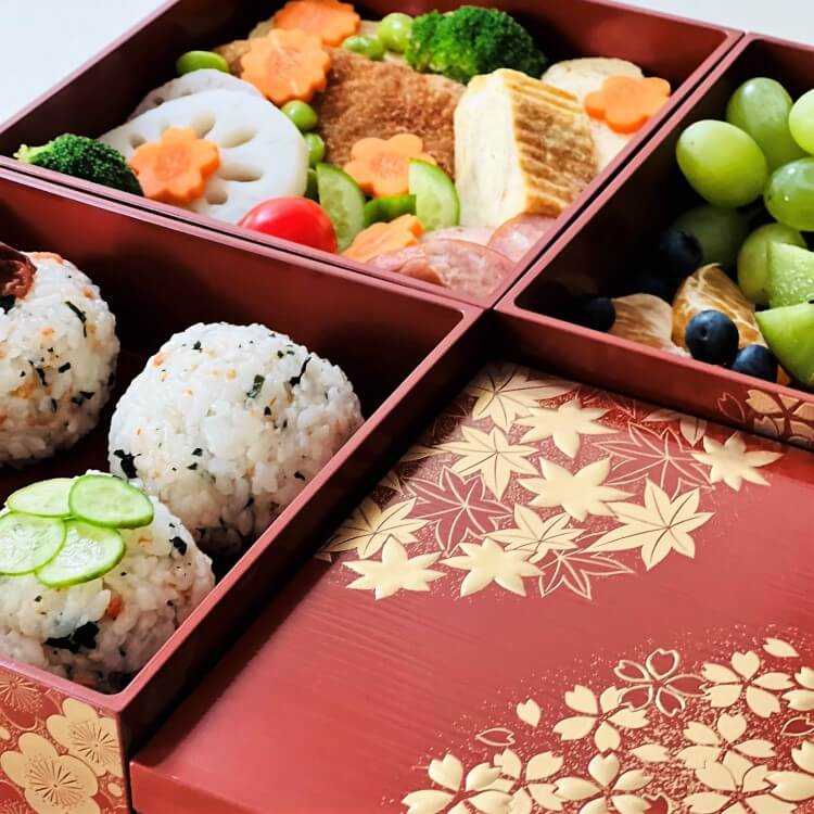close up shot showing lid and food in compartments hanamaru vermillion picnic bento box