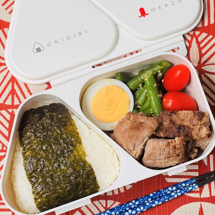 overhead photo of onigiri bento case with food