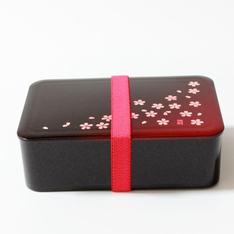 side view of sakura crimson 1 tier bento box with red lunch band